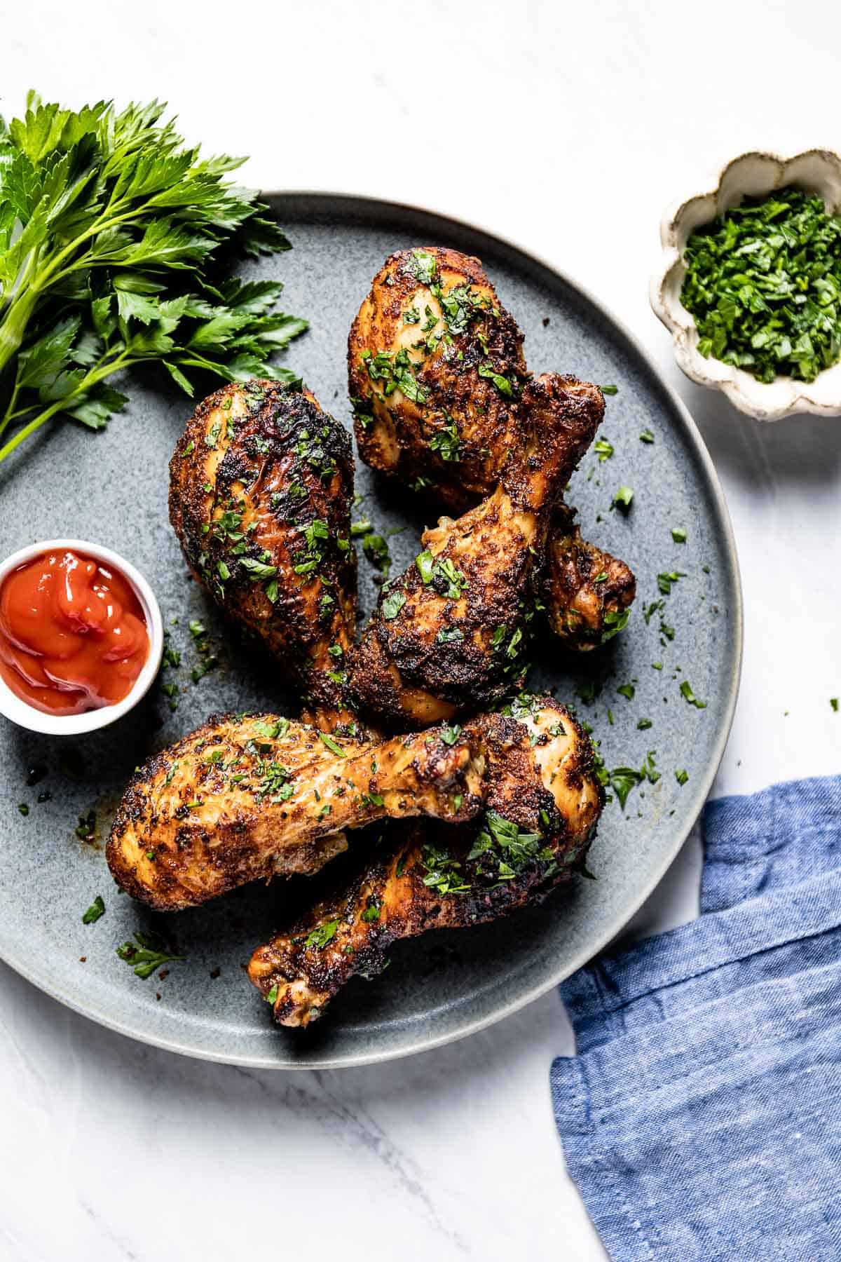 Air fried chicken legs on a plate from the top view